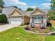 Attractive single-Gathering home with a well-maintained front yard and stylish outdoor seating at 409 Norton Xing, Woodstock, GA 30188