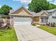 Attractive home with a well-manicured lawn, a two-car garage, and a charming brick facade at 409 Norton Xing, Woodstock, GA 30188
