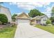 Lovely home with a well-maintained lawn, two-car garage, and inviting curb appeal at 409 Norton Xing, Woodstock, GA 30188