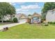 Beautiful home with lush green lawn and landscaping leading up to the front porch at 409 Norton Xing, Woodstock, GA 30188