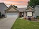 Charming brick home with a well-manicured lawn, two-car garage, and inviting front porch at 409 Norton Xing, Woodstock, GA 30188