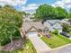 Charming one-story home featuring a manicured lawn, two-car garage, and welcoming front garden at 409 Norton Xing, Woodstock, GA 30188