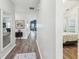 Bright hallway with wood floors, leading to the living area and bedrooms at 409 Norton Xing, Woodstock, GA 30188