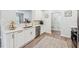 Contemporary kitchen showcasing white cabinets, stainless steel appliances, and quartz countertops at 409 Norton Xing, Woodstock, GA 30188