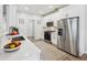 A modern kitchen with stainless steel appliances, white cabinets, quartz countertops, and a stylish backsplash at 409 Norton Xing, Woodstock, GA 30188
