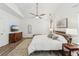 Bright main bedroom with hardwood floors, a ceiling fan, and neutral paint at 409 Norton Xing, Woodstock, GA 30188