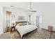 Spacious main bedroom with a ceiling fan, white walls, and hardwood flooring at 409 Norton Xing, Woodstock, GA 30188