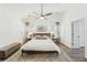 Bright main bedroom with wooden bed frame, white bedding and hardwood flooring at 409 Norton Xing, Woodstock, GA 30188