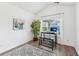 Modern home office with a minimalist desk, comfortable bench, and a calming view through the window at 409 Norton Xing, Woodstock, GA 30188