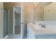Bright bathroom features a double sink vanity, shower and an open doorway to the bedroom at 4870 Heather Mill Trce, Snellville, GA 30039