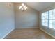 Elegant dining room with vaulted ceilings and a stylish chandelier at 4870 Heather Mill Trce, Snellville, GA 30039