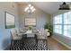 This dining room features bright light, a black-and-white rug, and modern furniture at 4870 Heather Mill Trce, Snellville, GA 30039