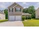 Charming two-story home with a two car garage and well-maintained lawn at 4870 Heather Mill Trce, Snellville, GA 30039