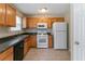 Functional kitchen featuring wooden cabinets and essential appliances at 4870 Heather Mill Trce, Snellville, GA 30039