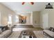 Staged living room with view of kitchen; features modern furnishings and neutral color palette at 4870 Heather Mill Trce, Snellville, GA 30039
