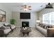 Staged living room with a fireplace, modern furniture, and a light-filled window at 4870 Heather Mill Trce, Snellville, GA 30039