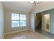An empty living room offers light-filled space, blonde wood floors, and potential for customization at 4870 Heather Mill Trce, Snellville, GA 30039
