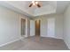 This bedroom includes private bathroom, closet, tray ceiling, and neutral carpet at 4870 Heather Mill Trce, Snellville, GA 30039