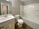 Bathroom with a tub-shower, a single sink vanity, and tile flooring at 7721 Fawn Cir, Covington, GA 30014
