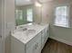 Bathroom featuring a double vanity with marble countertops at 7721 Fawn Cir, Covington, GA 30014