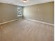 Bedroom with neutral carpeting, light paint, and a window at 7721 Fawn Cir, Covington, GA 30014