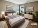 Well-lit staged bedroom features modern decor, including a bed, a dresser, and contemporary artwork at 7721 Fawn Cir, Covington, GA 30014