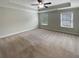 Spacious bedroom with tray ceiling and a ceiling fan at 7721 Fawn Cir, Covington, GA 30014