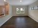 Dining area with hardwood flooring is well-lit with natural light from a large window at 7721 Fawn Cir, Covington, GA 30014