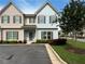 Charming townhome with a well-manicured lawn and colorful flower beds, complemented by a private parking area at 7721 Fawn Cir, Covington, GA 30014
