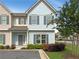 Charming two-story townhome with light blue siding, gray shutters, and well-manicured landscaping at 7721 Fawn Cir, Covington, GA 30014