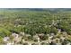 An aerial view of the neighborhood homes nestled among lush, green trees and landscaping at 1440 Water View Ln, Suwanee, GA 30024