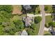 An aerial view showing the house nestled among mature trees in a residential neighborhood at 1440 Water View Ln, Suwanee, GA 30024