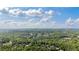 Aerial view showcases a neighborhood nestled among lush green trees at 1440 Water View Ln, Suwanee, GA 30024