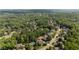 An aerial view of homes nestled amongst a dense green forest in a suburban community at 1440 Water View Ln, Suwanee, GA 30024