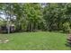 Spacious lawn area with ample space for recreation, set within a private and wooded backyard at 1440 Water View Ln, Suwanee, GA 30024