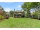 Lovely backyard with a screened porch, patio, and mature trees; ideal for entertaining and relaxing at 1440 Water View Ln, Suwanee, GA 30024