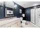 Beautiful bathroom featuring a walk-in shower, modern vanity, and sophisticated navy walls at 1440 Water View Ln, Suwanee, GA 30024