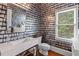 Charming powder room boasting modern vanity with unique wallpaper and natural light at 1440 Water View Ln, Suwanee, GA 30024