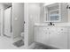This bathroom has white cabinets, tile floors, a large mirror, and an updated vanity at 1440 Water View Ln, Suwanee, GA 30024
