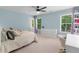 Serene bedroom with light blue walls, two windows, and a plush carpet creating a cozy retreat at 1440 Water View Ln, Suwanee, GA 30024