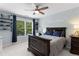Inviting bedroom with natural light, dark wood accents, shelves filled with decor, and light blue walls at 1440 Water View Ln, Suwanee, GA 30024