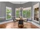 Charming breakfast nook features patterned wallpaper, large windows, and a modern chandelier at 1440 Water View Ln, Suwanee, GA 30024