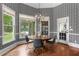 Cozy breakfast nook with decorative wallpaper and multiple windows overlooking the lush backyard at 1440 Water View Ln, Suwanee, GA 30024