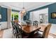 Dining room features a stylish chandelier, large window, and access to an office at 1440 Water View Ln, Suwanee, GA 30024