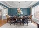 Formal dining room showcasing a chandelier, wainscoting, and dining table for eight at 1440 Water View Ln, Suwanee, GA 30024