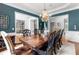 Dining room with elegant decor including a large table, chandelier, and beautiful wall color at 1440 Water View Ln, Suwanee, GA 30024