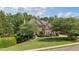 Brick home with mature trees and a beautifully maintained lawn at 1440 Water View Ln, Suwanee, GA 30024