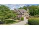 Charming residence featuring well-maintained landscaping, a brick facade, and a spacious driveway at 1440 Water View Ln, Suwanee, GA 30024
