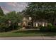 Charming two-story brick home with a well-manicured lawn, mature trees, and tasteful landscaping at 1440 Water View Ln, Suwanee, GA 30024