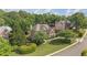 Beautifully landscaped front yard of a two-story brick home with mature trees and lush green grass at 1440 Water View Ln, Suwanee, GA 30024